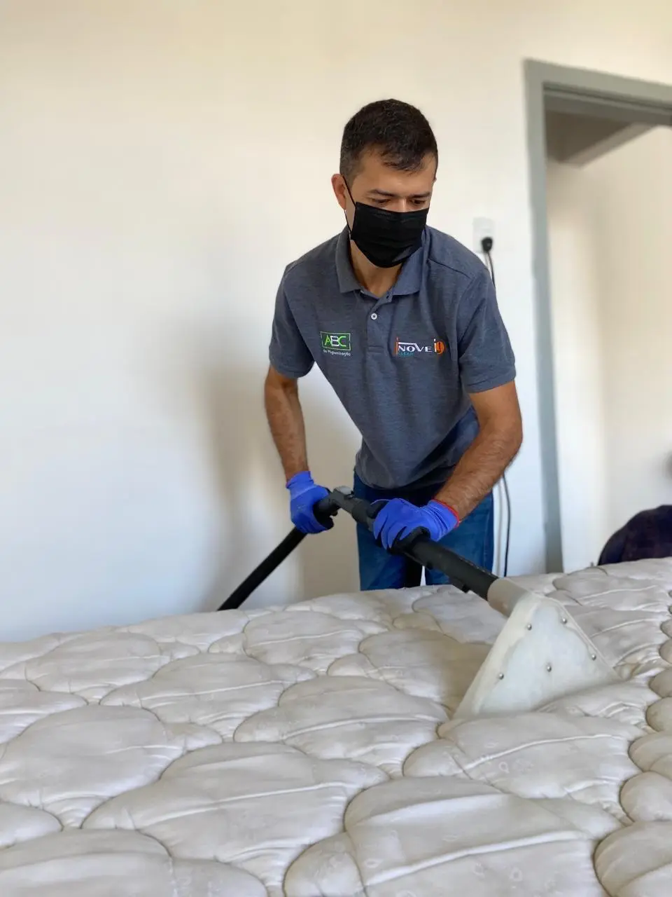 Técnico uniformizado da Inove Clean higienizando colchão